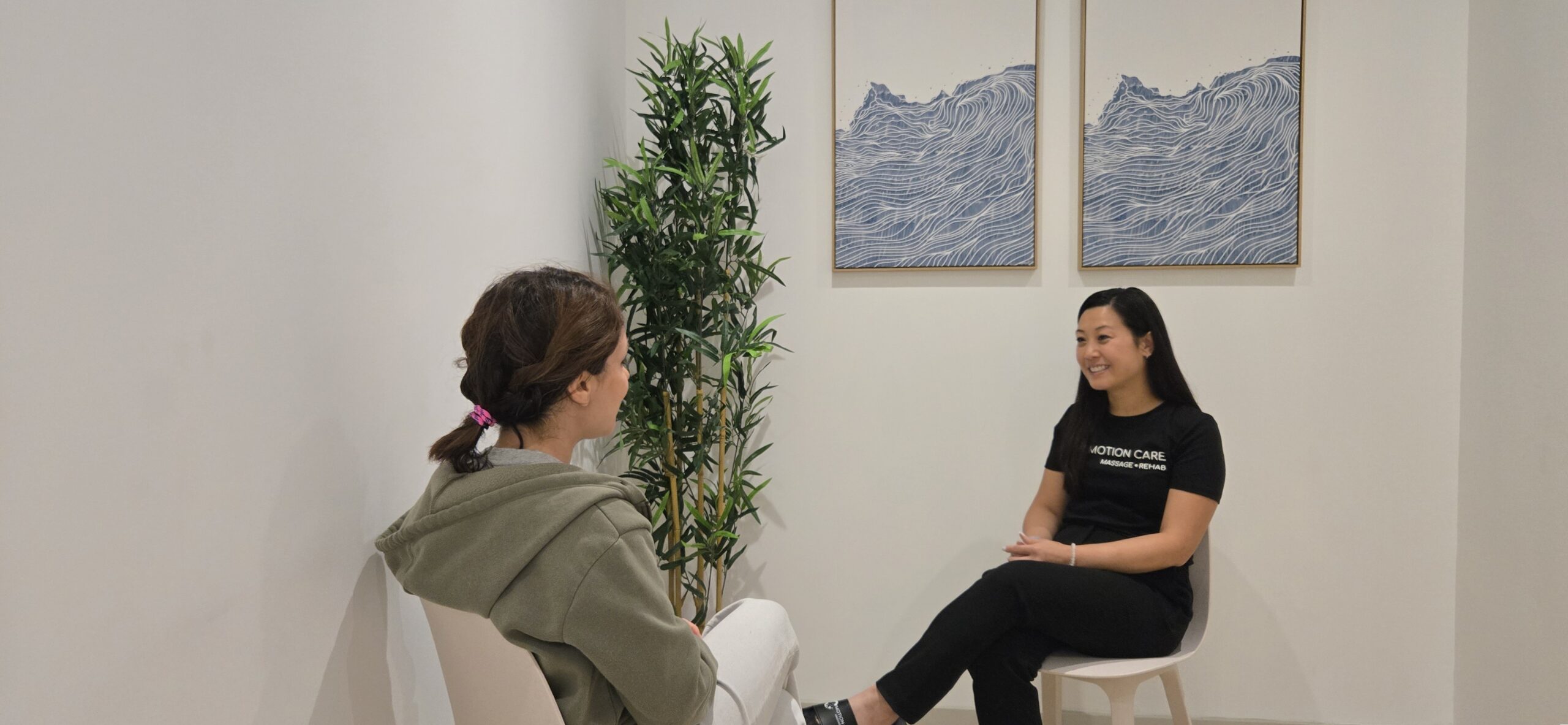 Psychotherapy session at Motion Care Clinic in North York, showing a practitioner and patient seated in a warm counselling space.